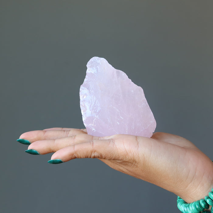 raw rose quartz in hand