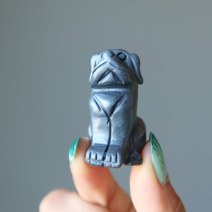 finger tips holding Hematite Dog