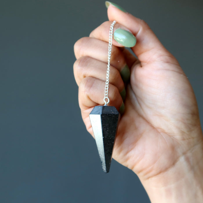 hematite pendulum in hand