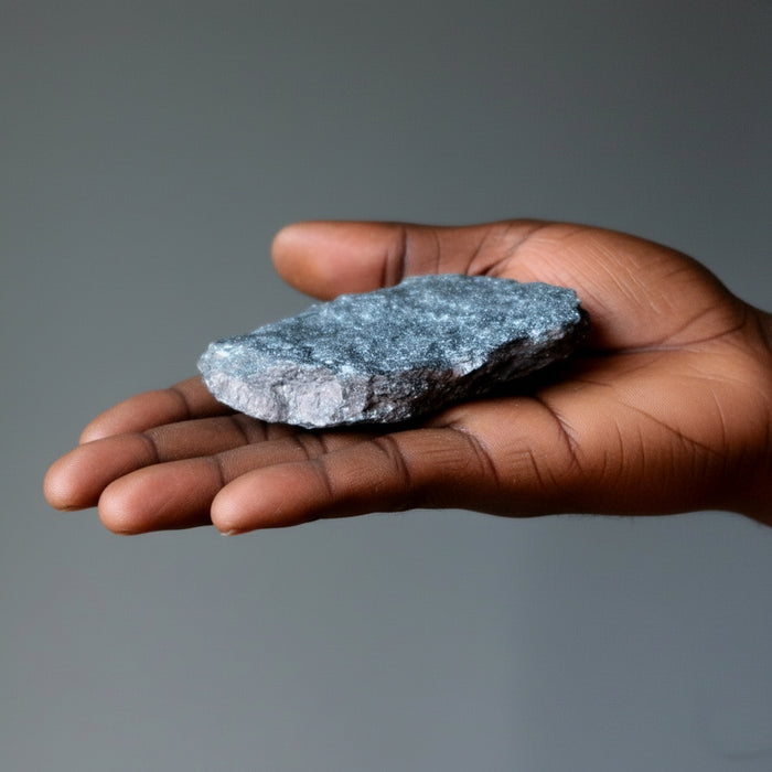 raw specular hematite stone in hand