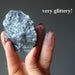 raw specular hematite stone in hand showing the glitter