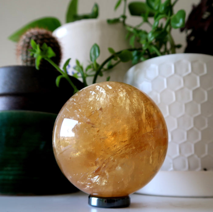 honey calcite sphere on hematine ring stand