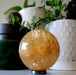 honey calcite sphere on hematine ring stand