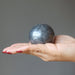 hand holding hematite sphere