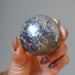 hand holding hematite sphere