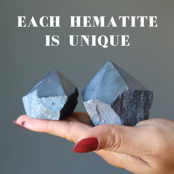 hand holding two hematite towers