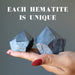 hand holding two hematite towers