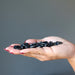 palm holding Hematite Tumbled Stones