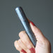 hand holding a hematite massage wand