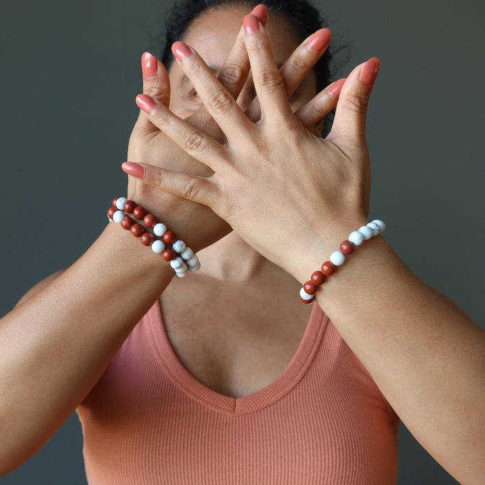 model wearing two howlite redjasper bracelets on right wrist and one on left wrist 