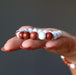 holding Howlite Red Jasper Bracelet on the palm