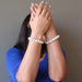 female with hands up in front fo her face modeling howlite stretch bracelets