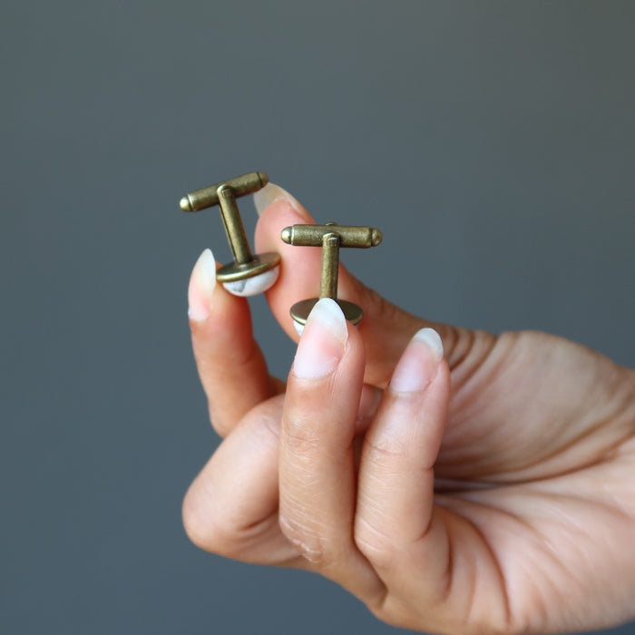 hands holding howlite cufflinks
