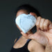 woman holding howlite heart