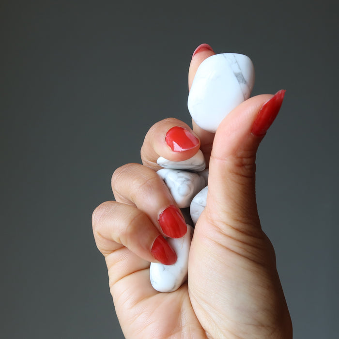 hand holding howlite tumbled stones