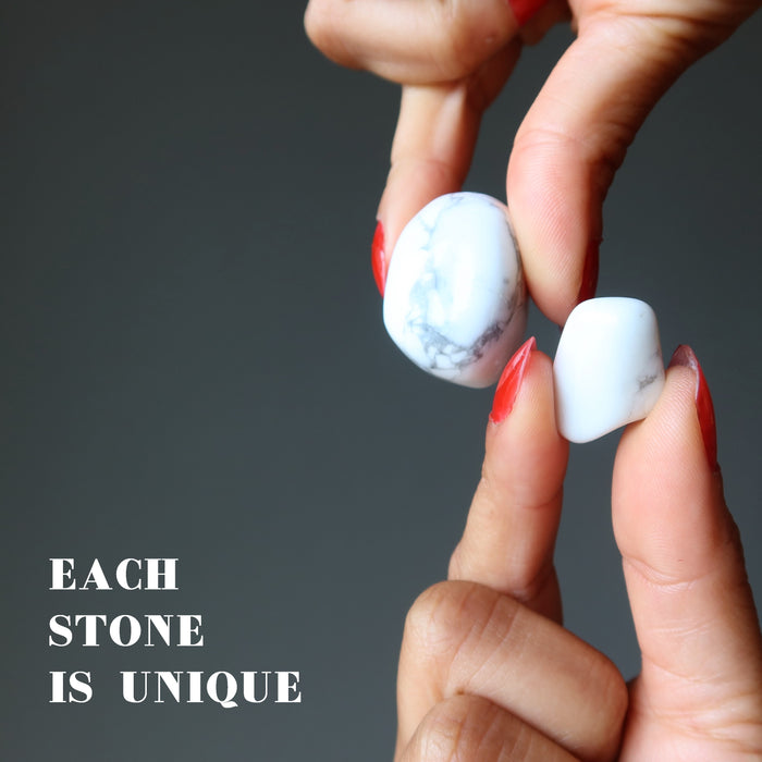 hand holding howlite tumbled stones to show each is unique