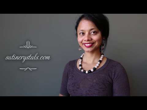 video featuring rainbow obsidian wood necklaces