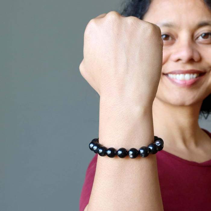 sheila of satin crystals with fist up wearing hypersthene bracelet