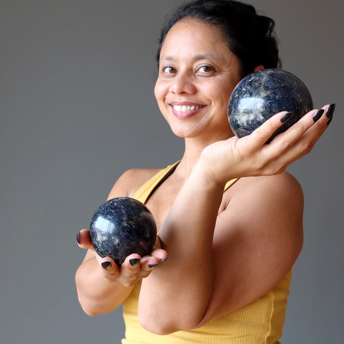 sheila of satin crystals holding two iolite spheres