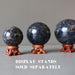 three iolite spheres on fancy wood stands