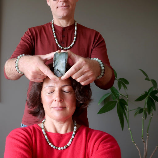 man healing woman with jade