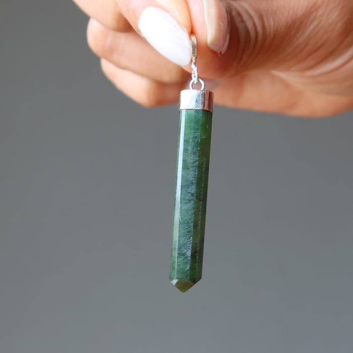 hand holding jade faceted point pendant