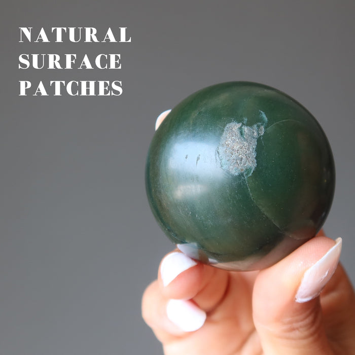 hand holding dark green nephrite jade sphere