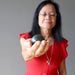 woman meditating with dark green nephrite jade sphere