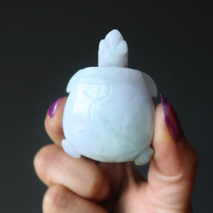 hand holding green jadeite jade turtle carving