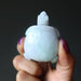hand holding green jadeite jade turtle carving