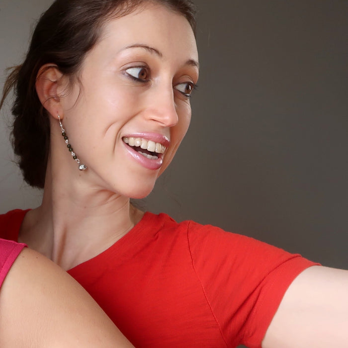 woman modeling jade skull earrings