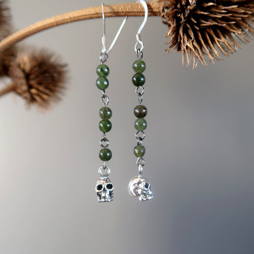 skull jade earrings on branch