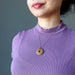 sheila of satin crystals wearing Brown Jasper Donut Amulet on 14k Rose Gold necklace