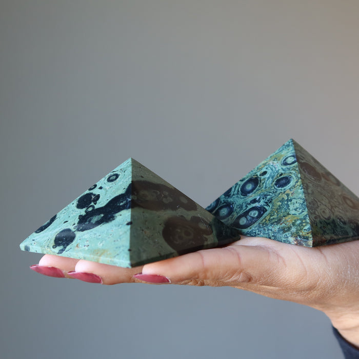 holding two Kambaba Green Jasper Pyramids