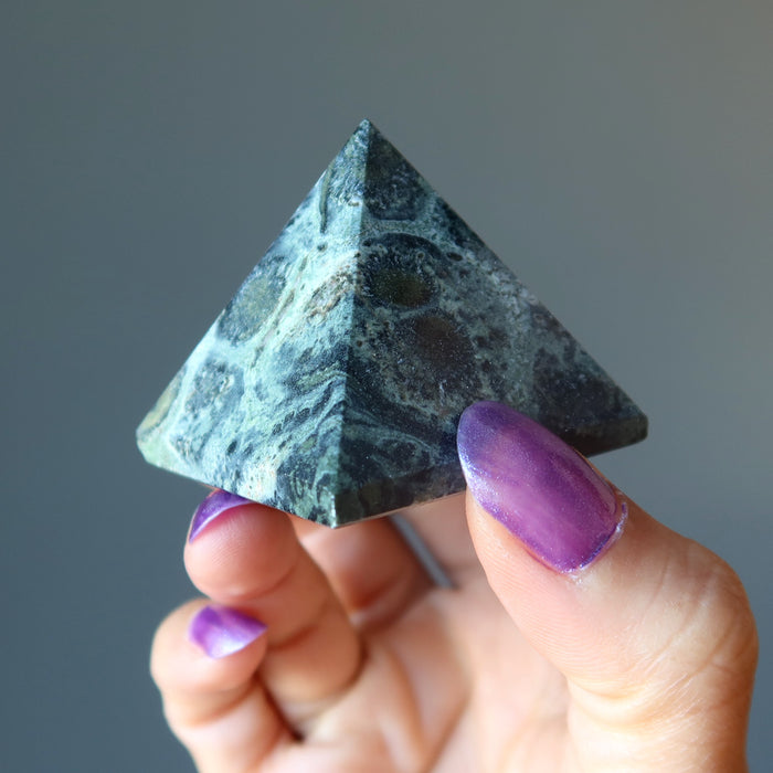 hand holding Kambaba Green Jasper Pyramid