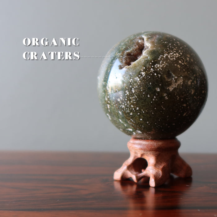spotted ocean jasper sphere on wood stand