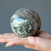 spotted ocean jasper sphere in hand
