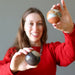 woman holding two polychrome jasper spheres