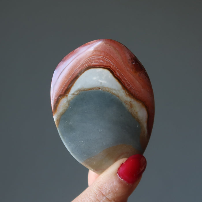 hand holding polychrome jasper crystal 