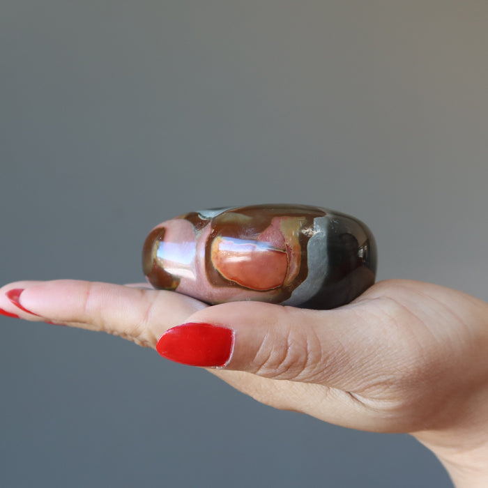 hand holding polychrome jasper heart