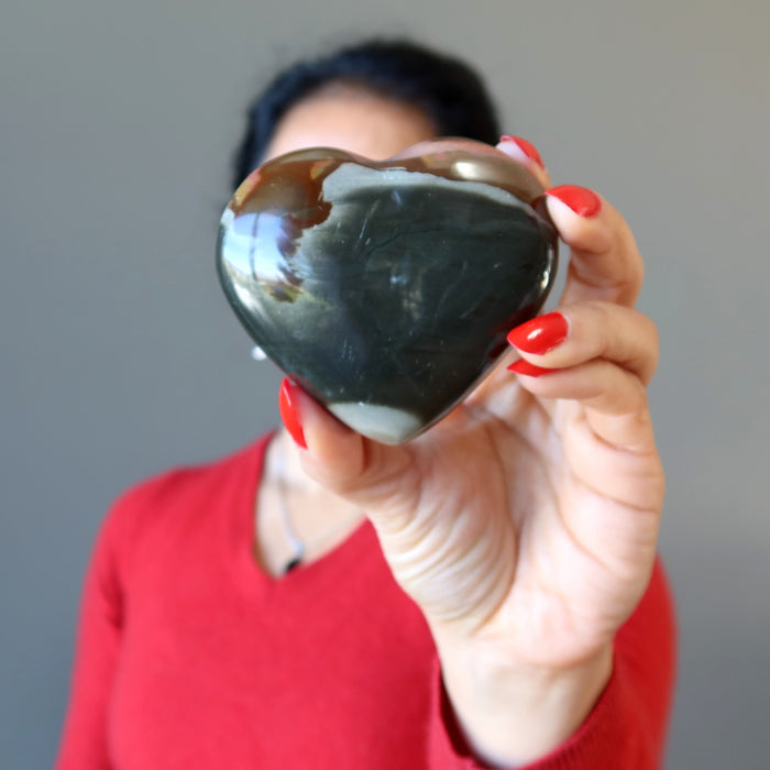 hand holding polychrome jasper heart
