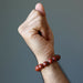 hand wearing red jasper bracelet