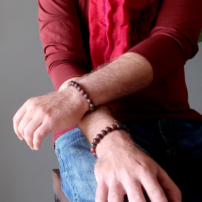 man wearing red brecciated jasper bracelets