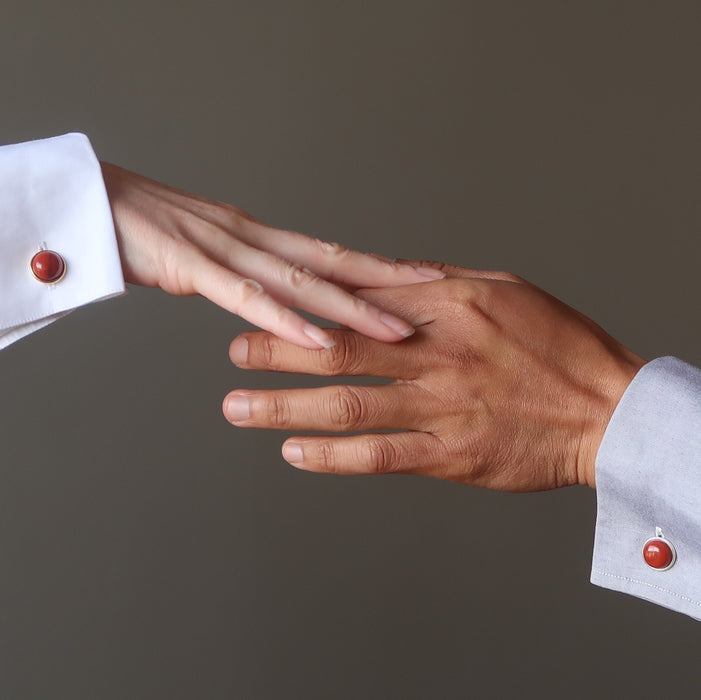 hands touching wearing red jasper cufflinks