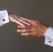 hands touching wearing red jasper cufflinks