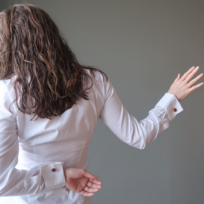woman with her back turned posing with red jasper cufflinks