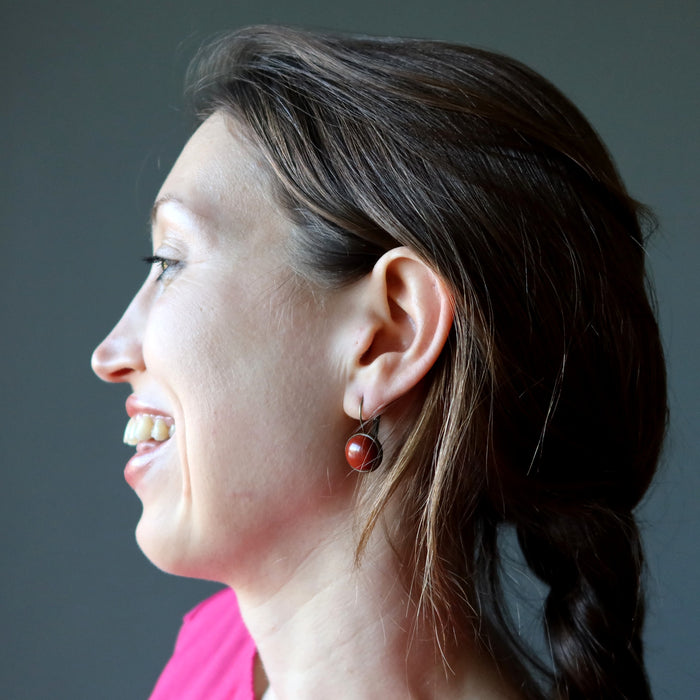 holly of satin crystals wearing red jasper in antique bronze leverback earrings