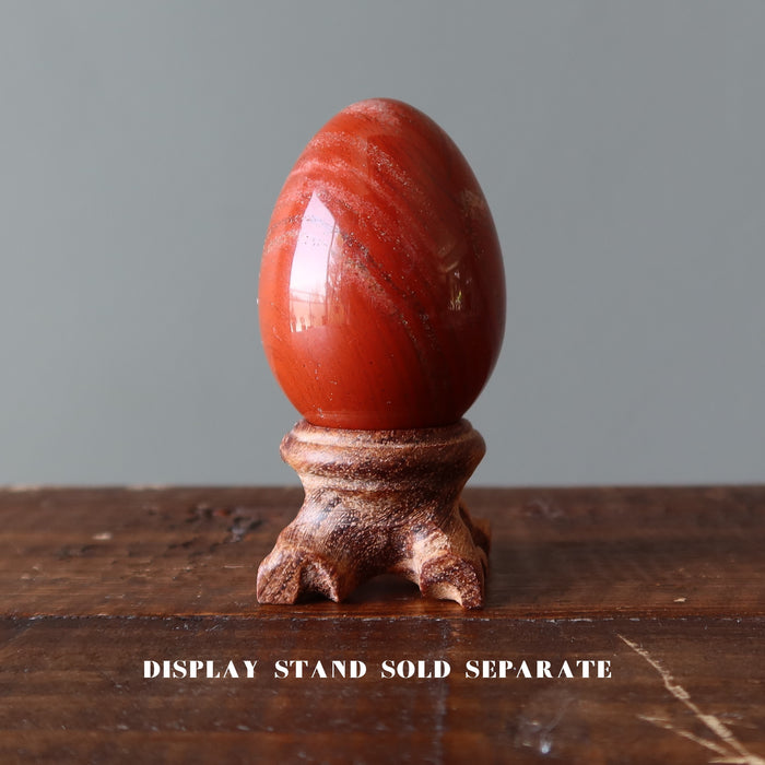 red jasper egg on display stand