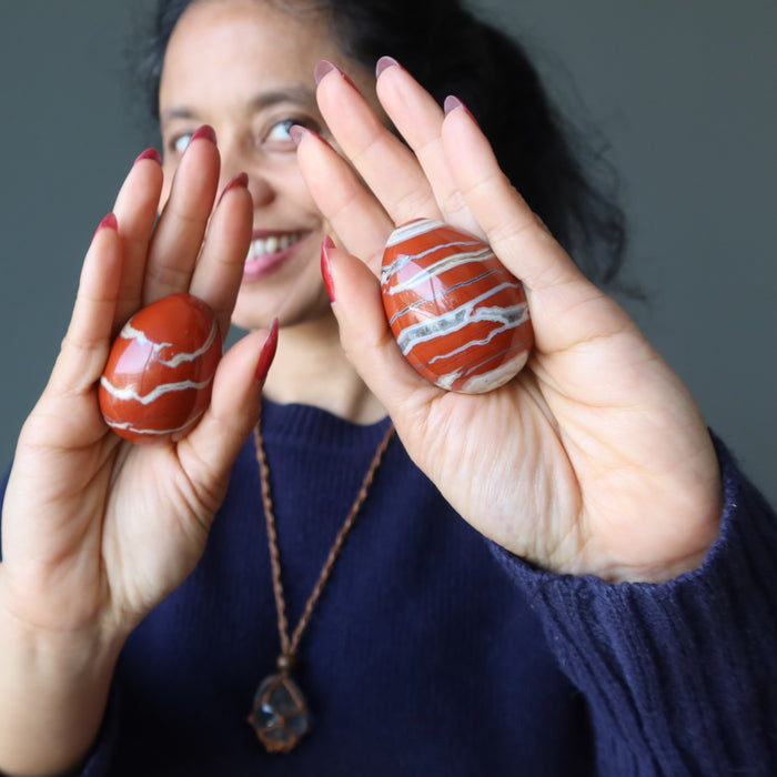 woman holding red jasper eggs
