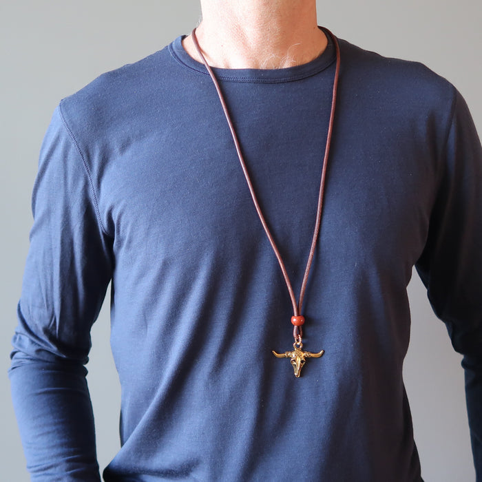 man wearing jasper bull skull necklace